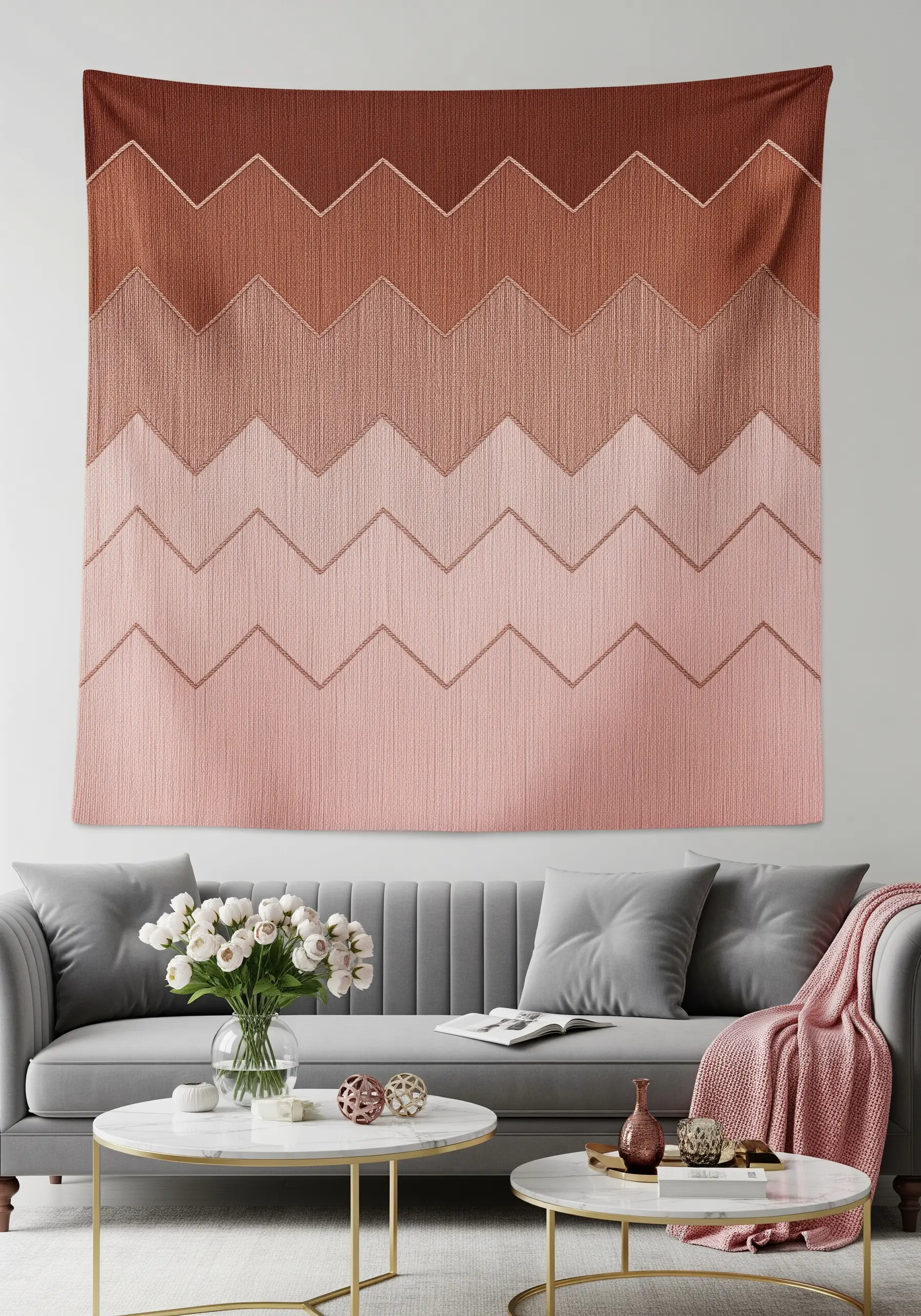 A large wall tapestry with a chevron pattern fading from dark terracotta to light pink.