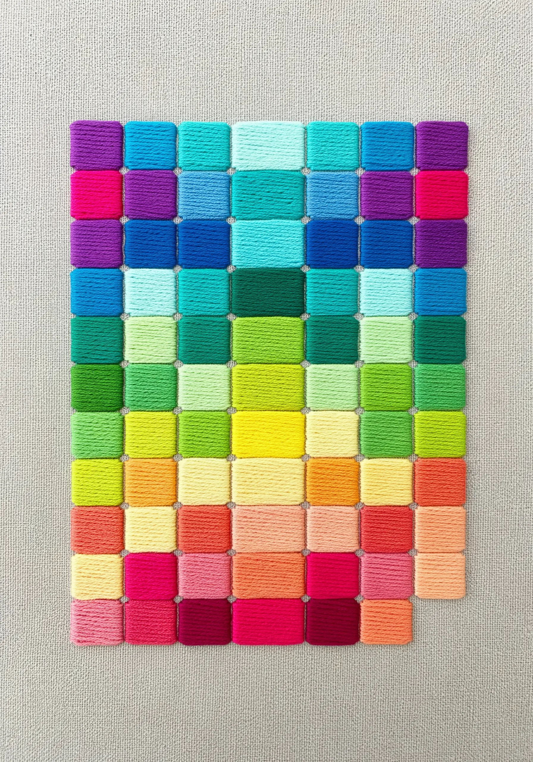 Grid of colorful satin stitch squares arranged by hue