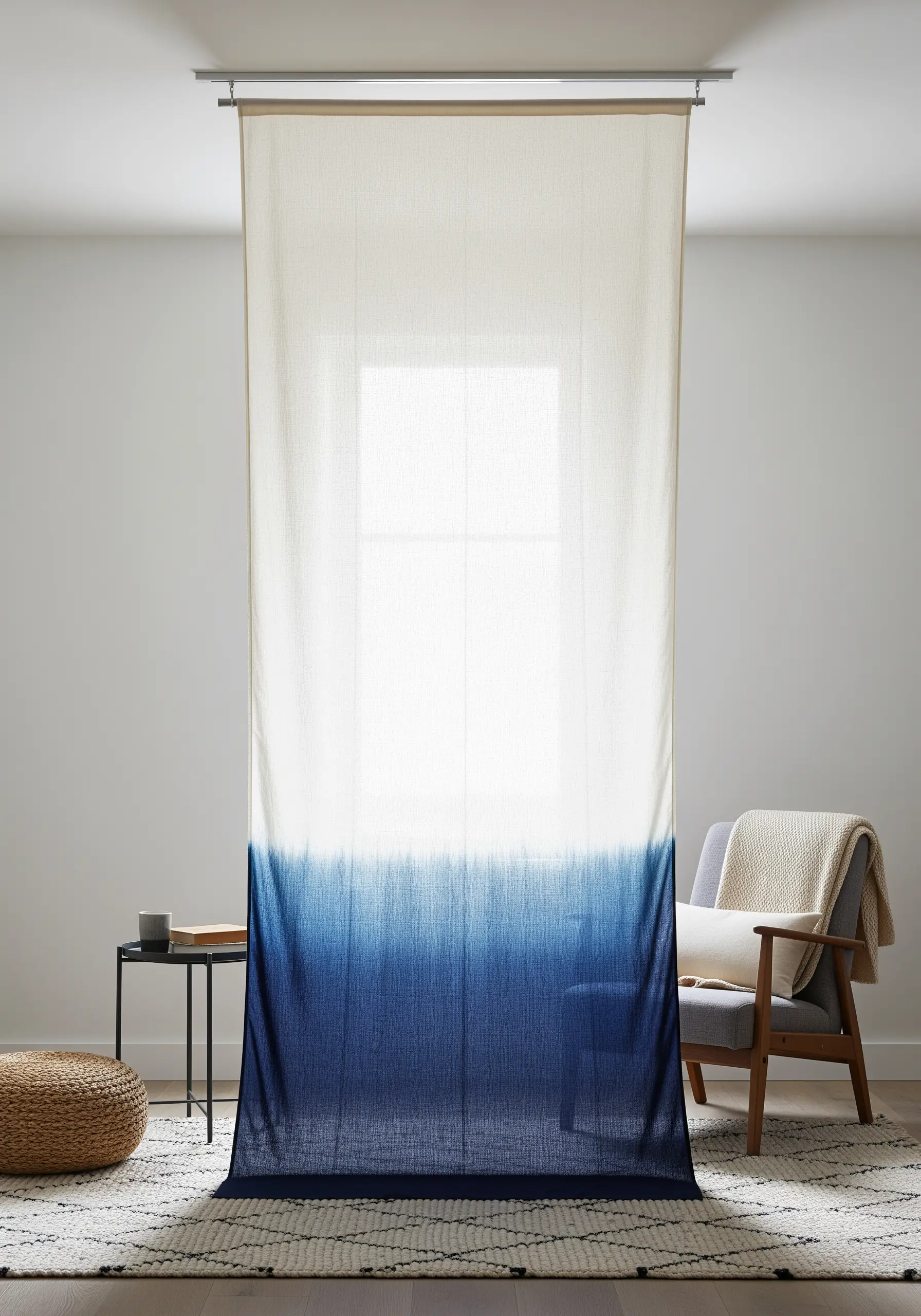 A sheer white curtain with a dark blue dip-dye effect at the bottom.