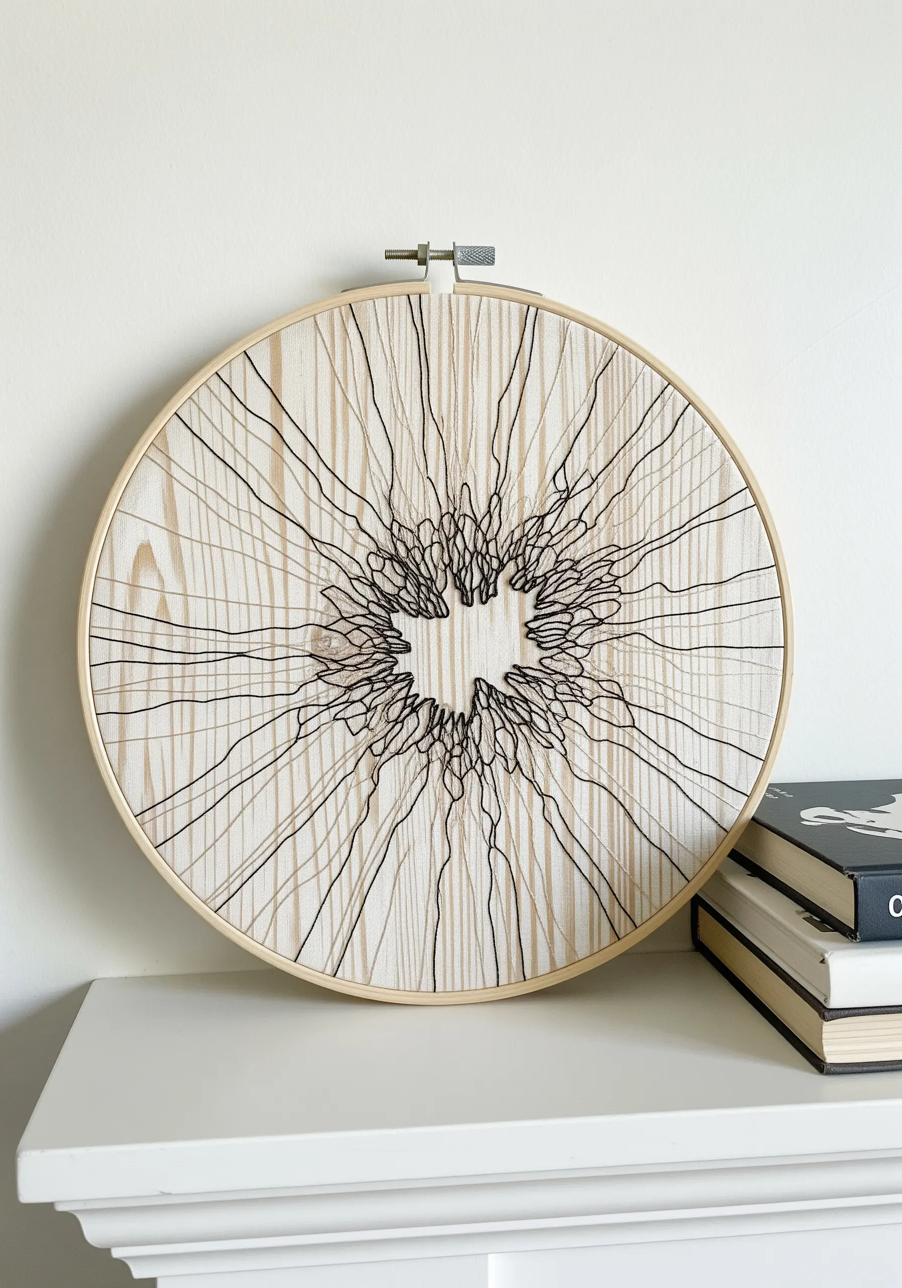 Minimalist black thread embroidery tracing the lines on a wood-grain patterned fabric.