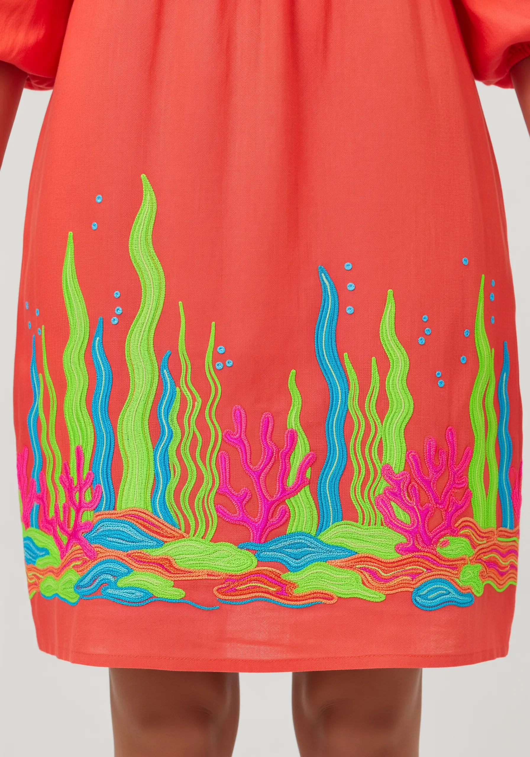 Coral dress with colorful embroidered seaweed and coral reef border