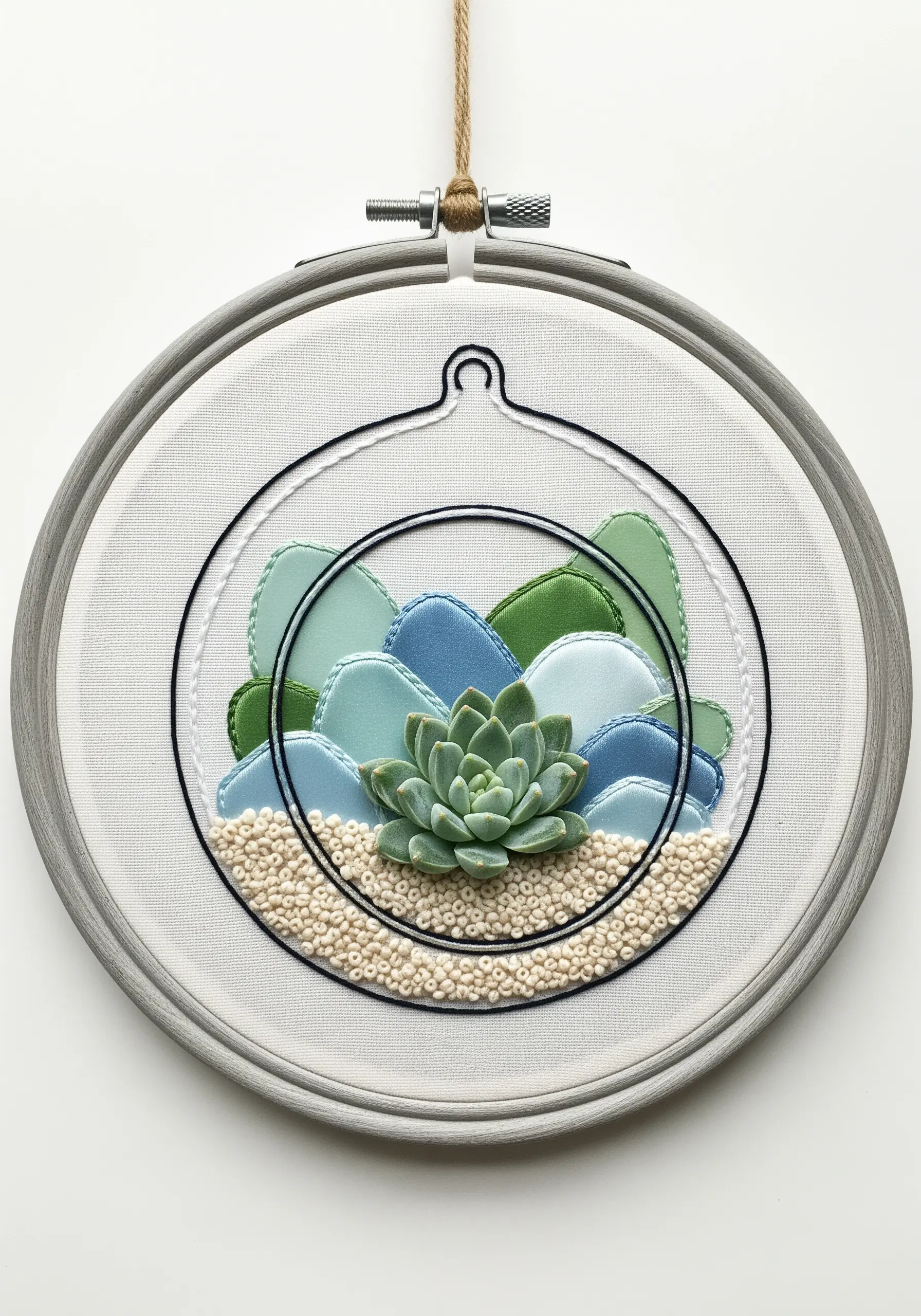 Mixed-media terrarium with fabric appliqué stones and a central embroidered succulent