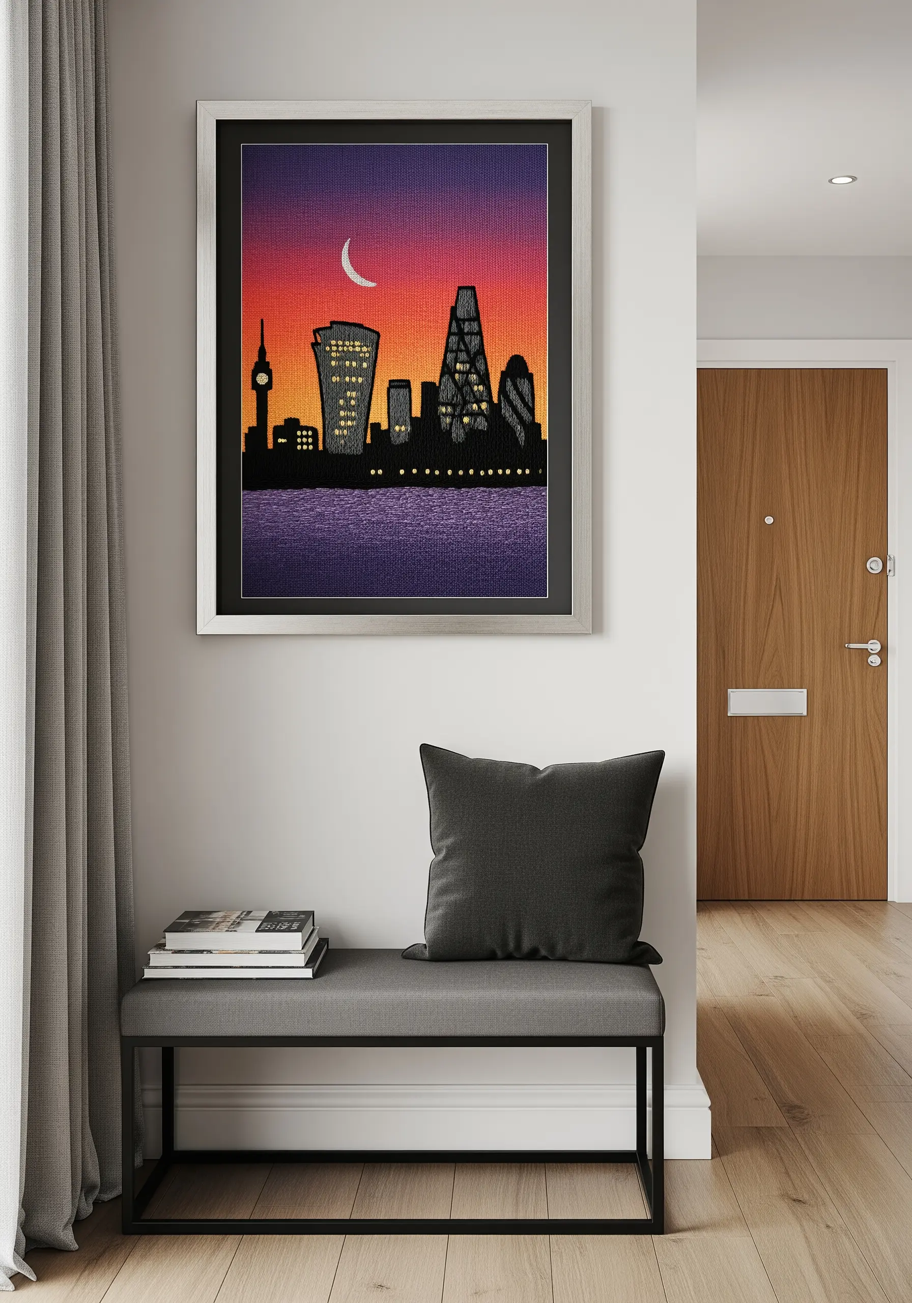 An embroidered cityscape silhouette against a vibrant, thread-painted sunset of orange and purple.
