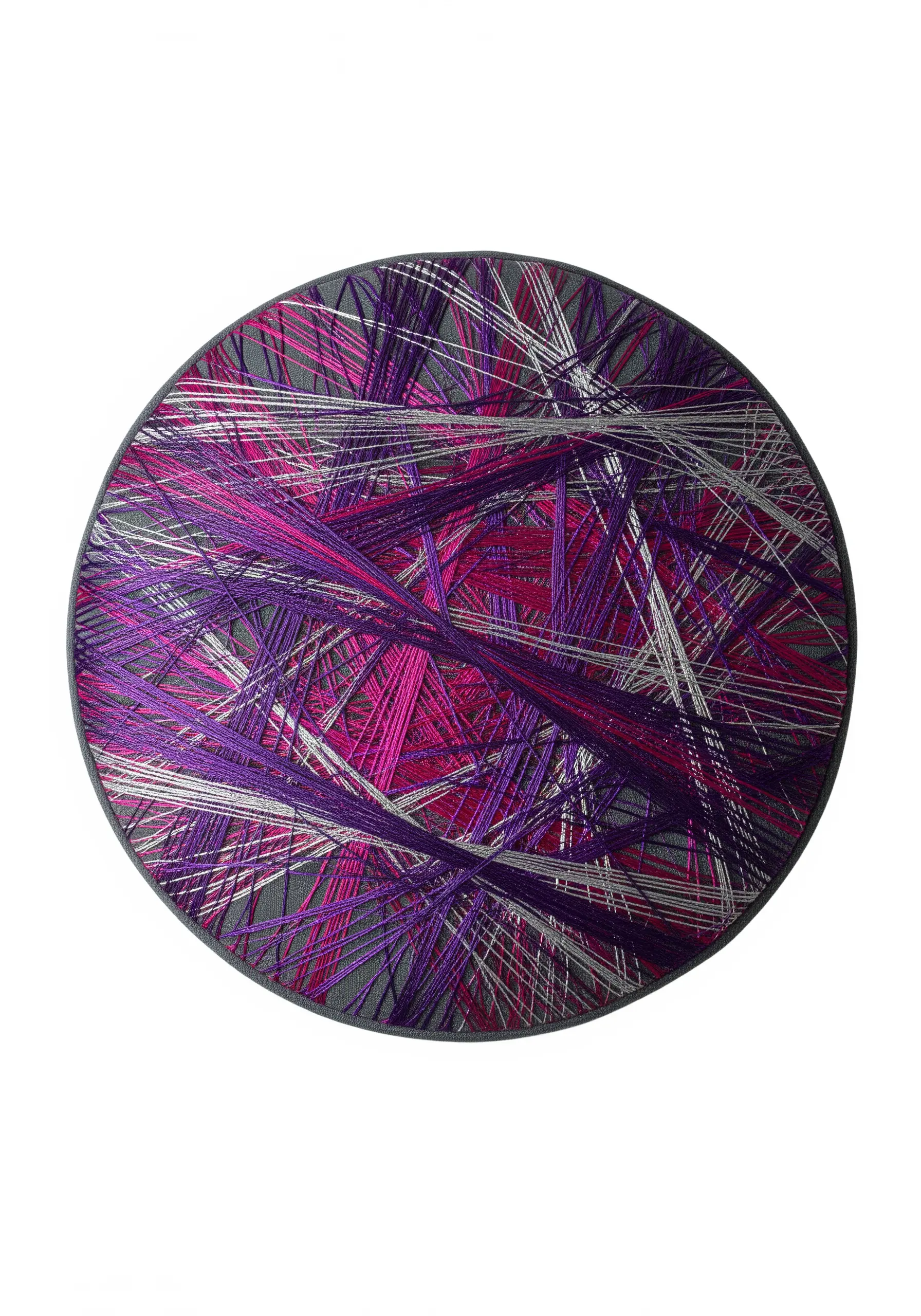 An oval composition of overlapping straight stitches in purple, pink, and silver metallic threads
