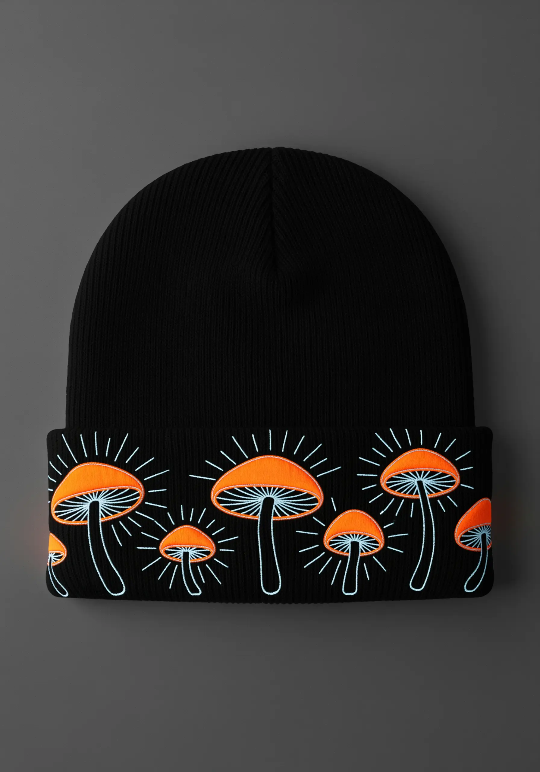 A group of glowing mushrooms in orange and light blue on the cuff of a black beanie.