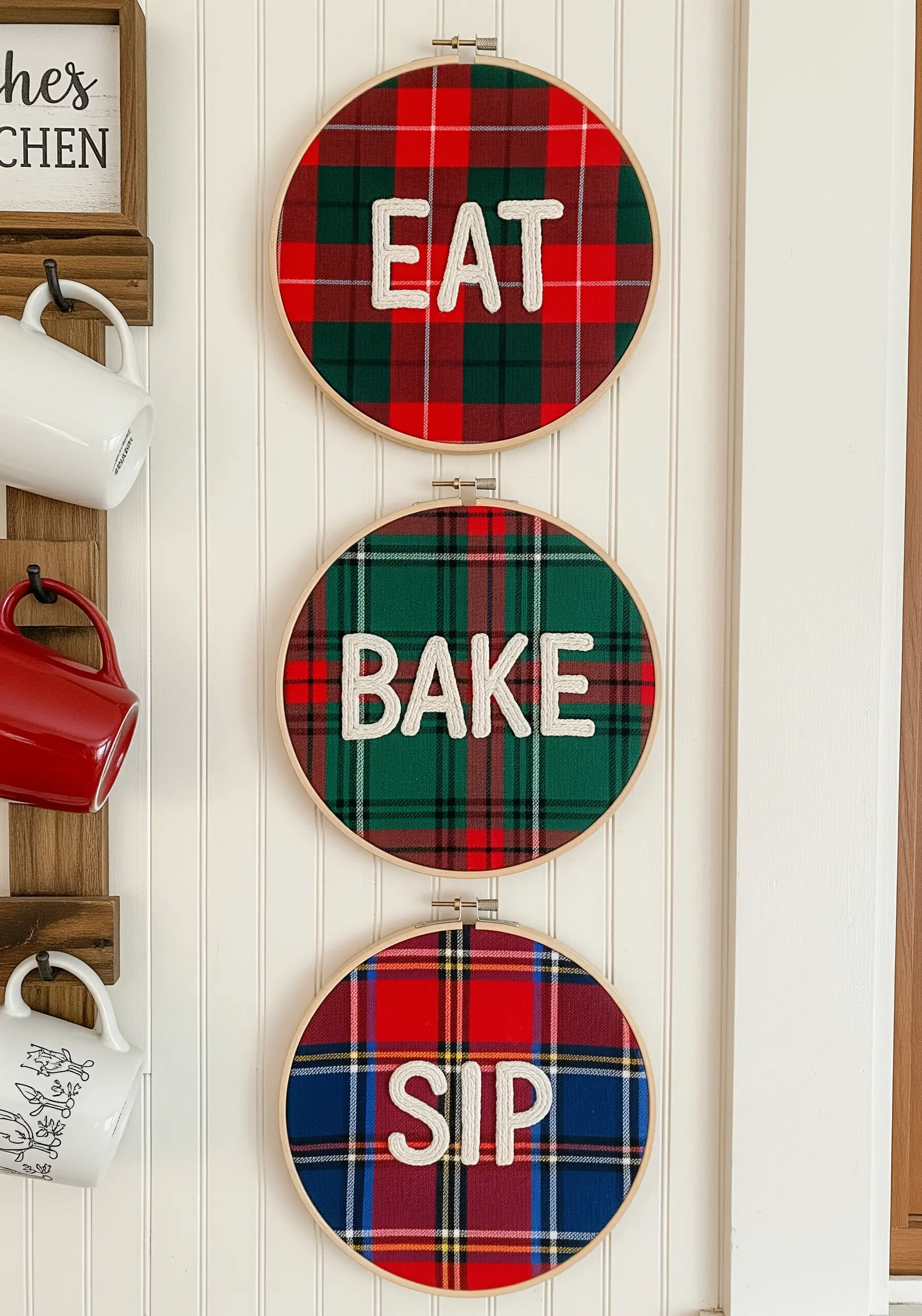Three embroidery hoops with plaid fabric and chunky white text saying 'EAT,' 'BAKE,' 'SIP.'