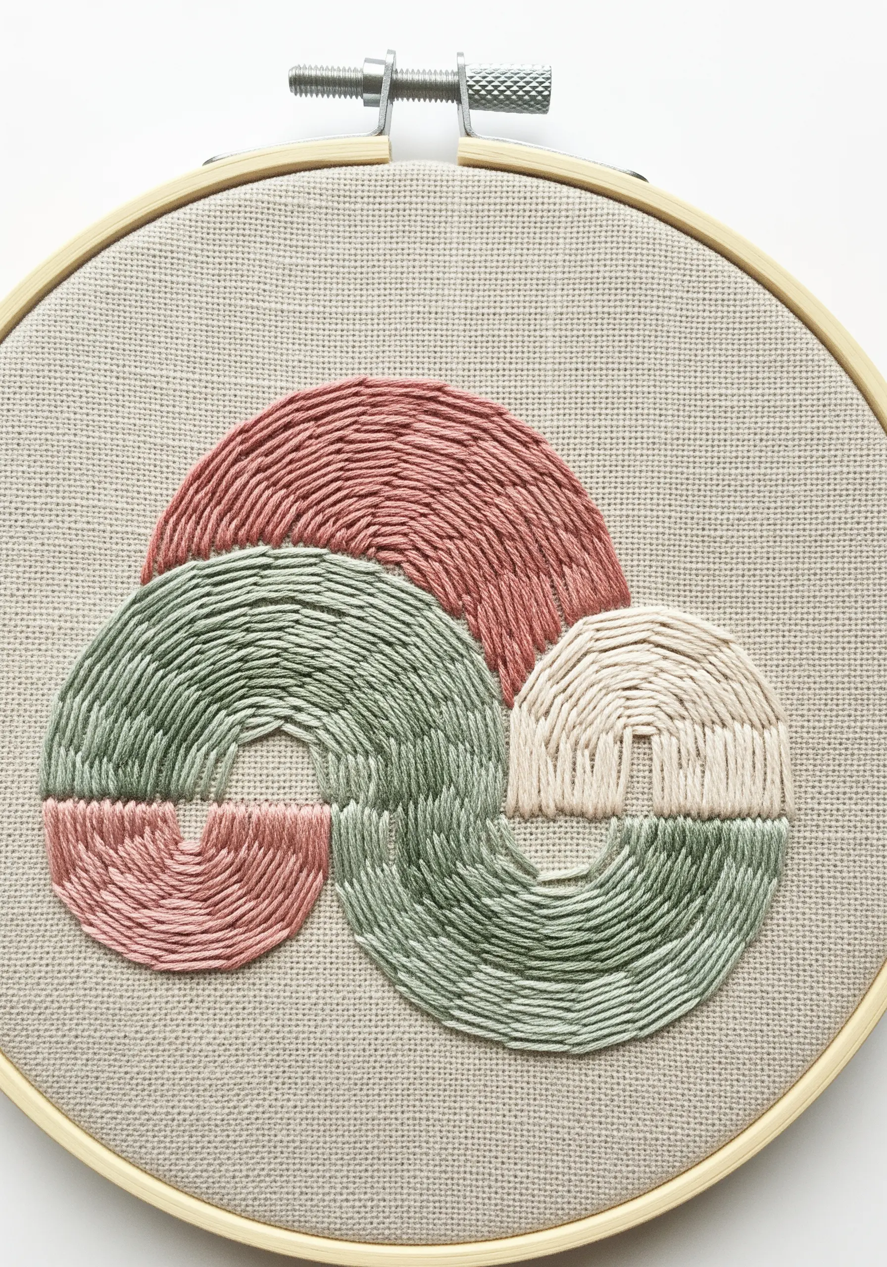 An abstract design with three interlocking curved shapes in muted pink, green, and cream.