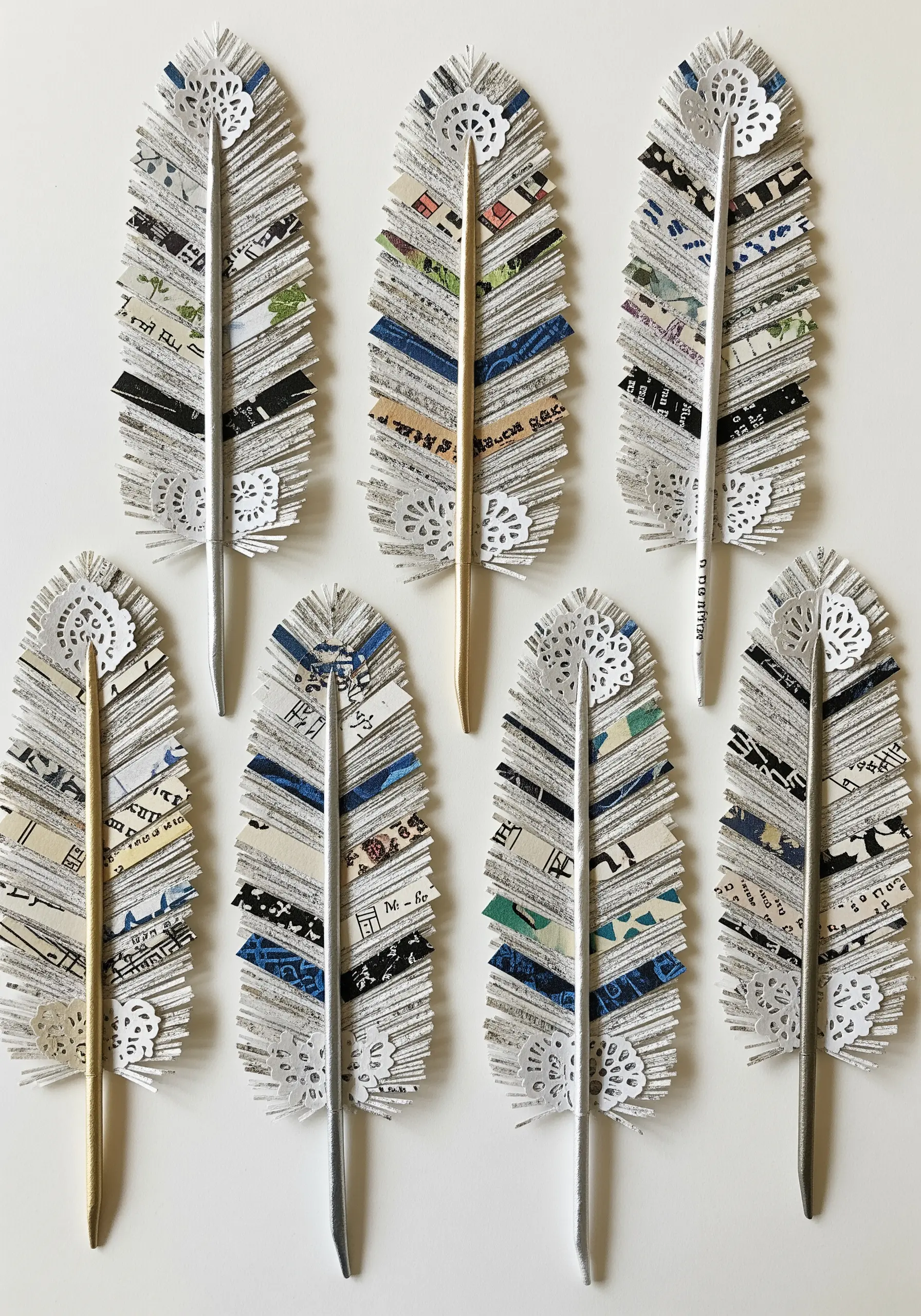 Eight paper feathers decorated with strips of patterned and musical note paper.