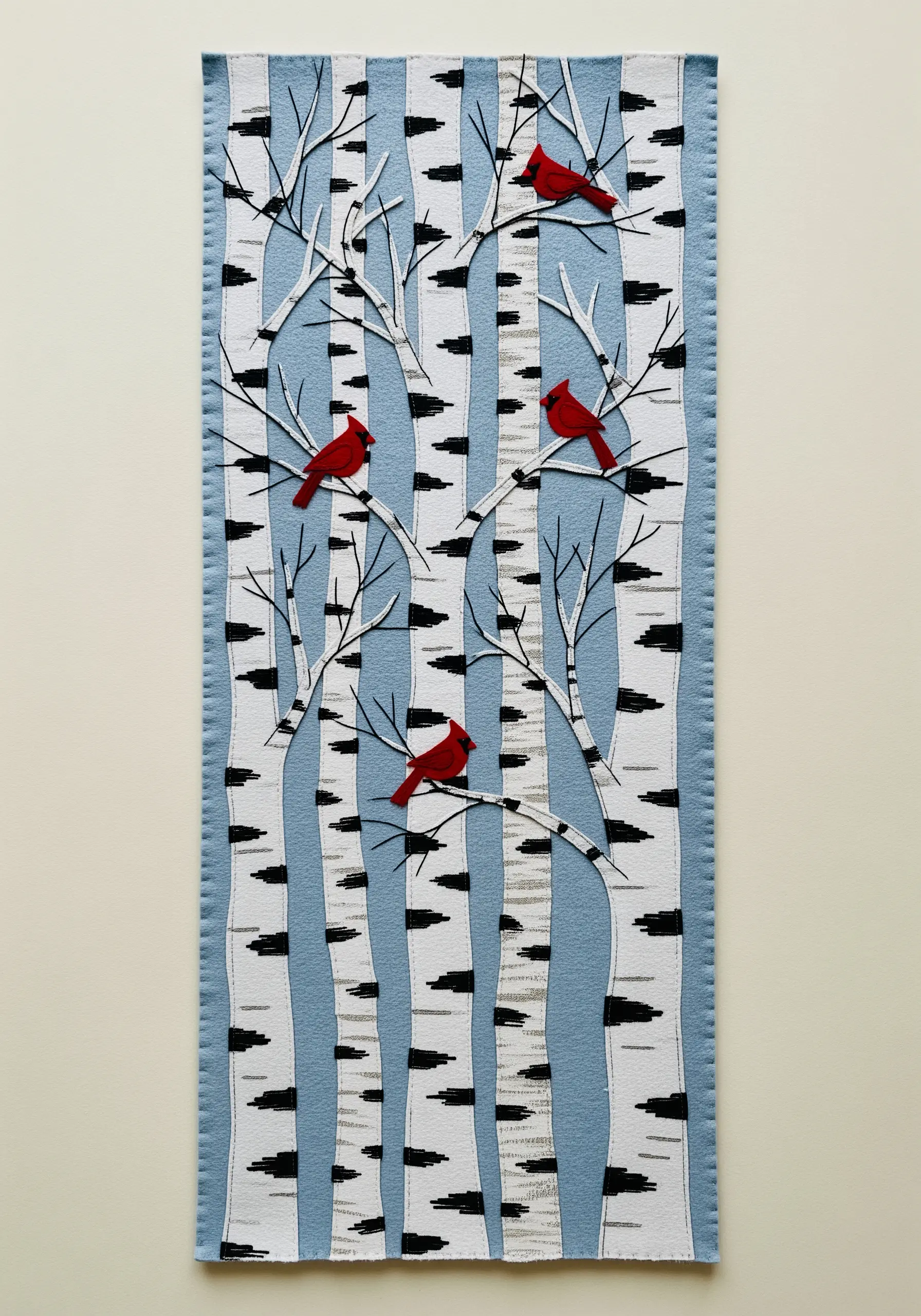 Birch tree wall hanging using patterned fabric for the trunks and red felt cardinals.
