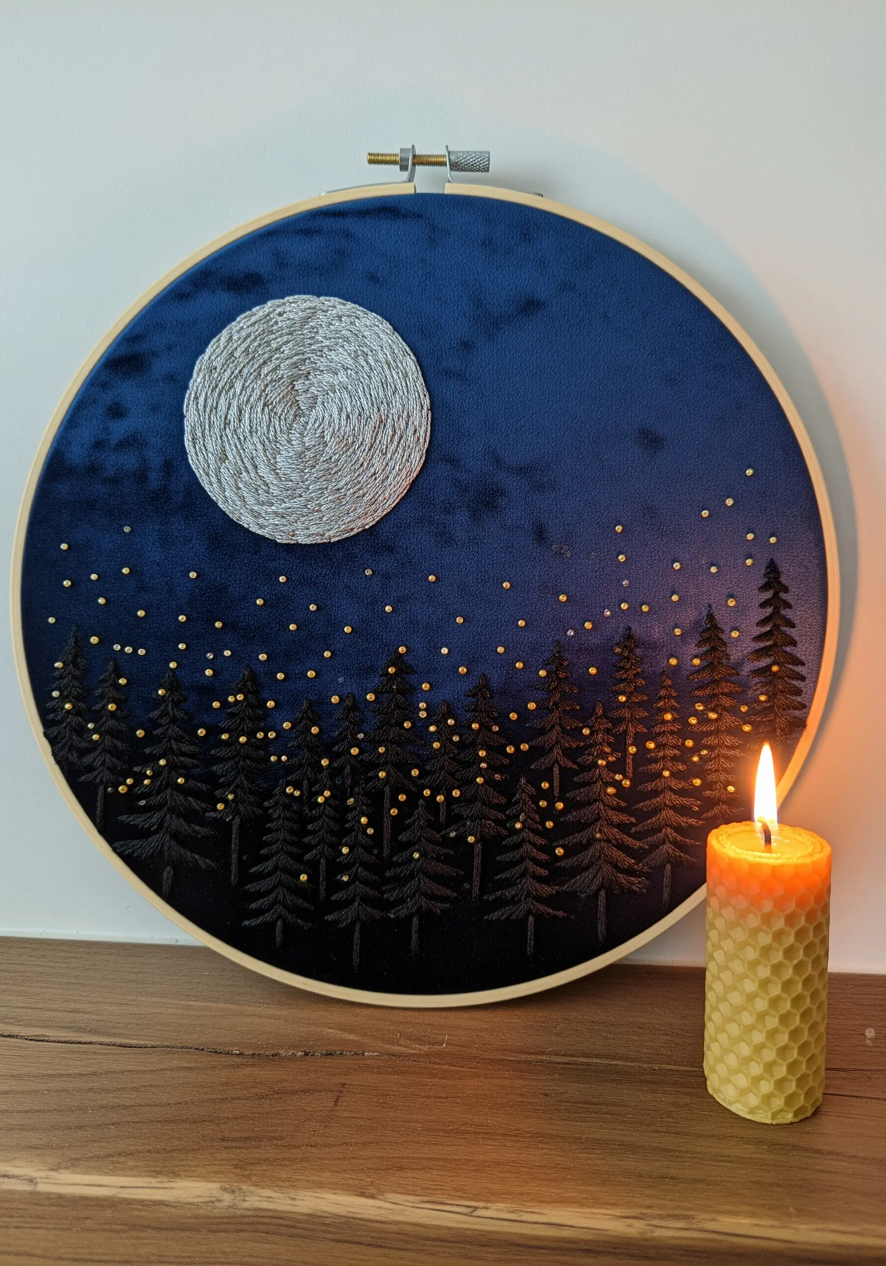Full moon and forest silhouette embroidered on dark blue velvet