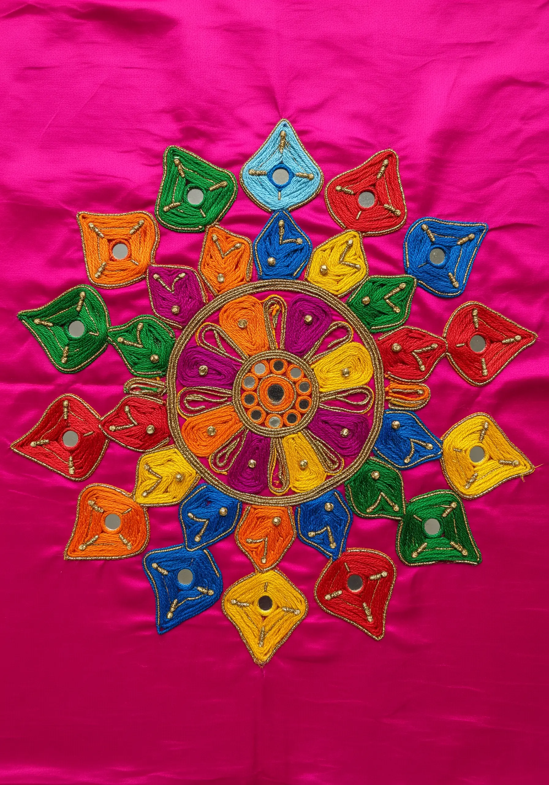 Colorful mandala embroidery with Shisha mirror work on a bright pink fabric.