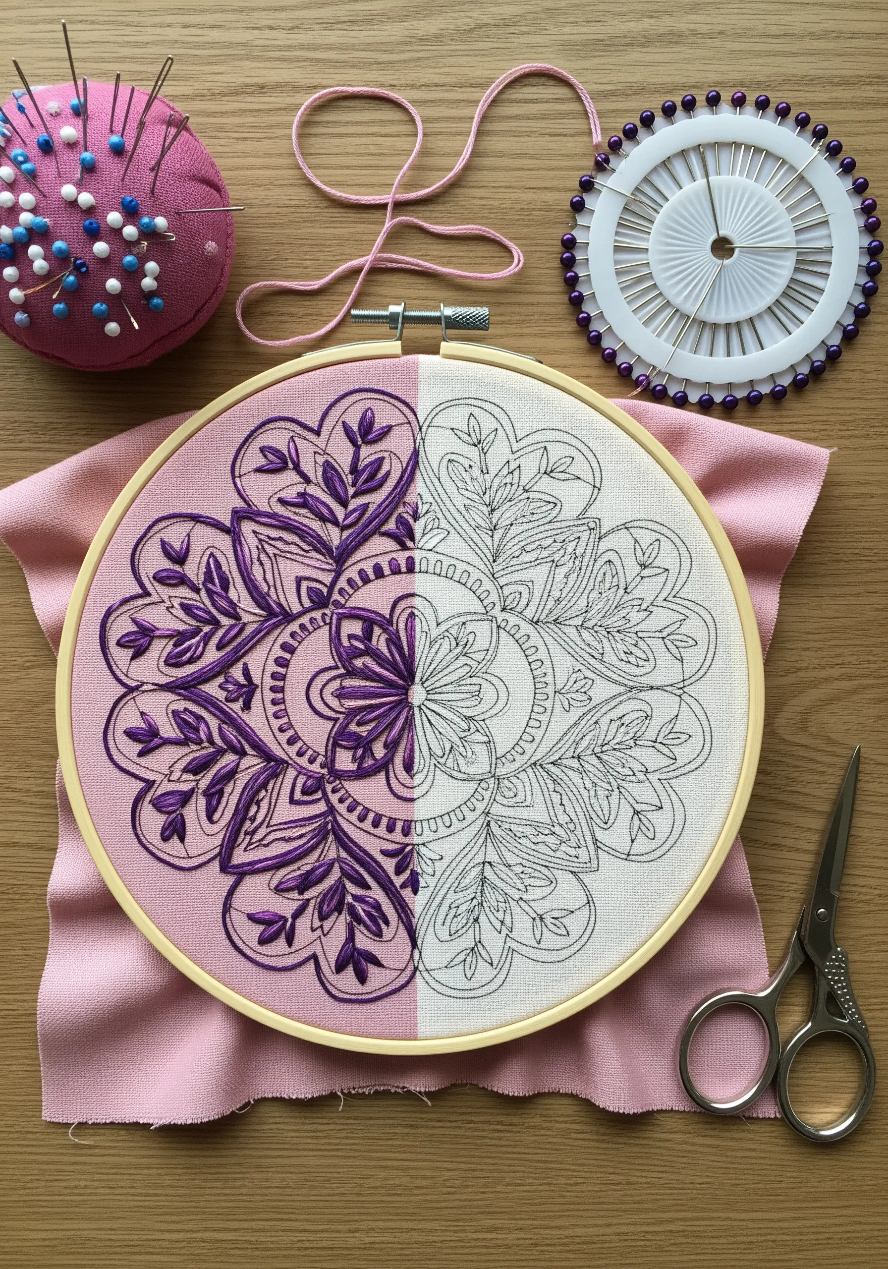 A half-stitched mandala on split pink and white fabric, showing the pattern and the finished embroidery.