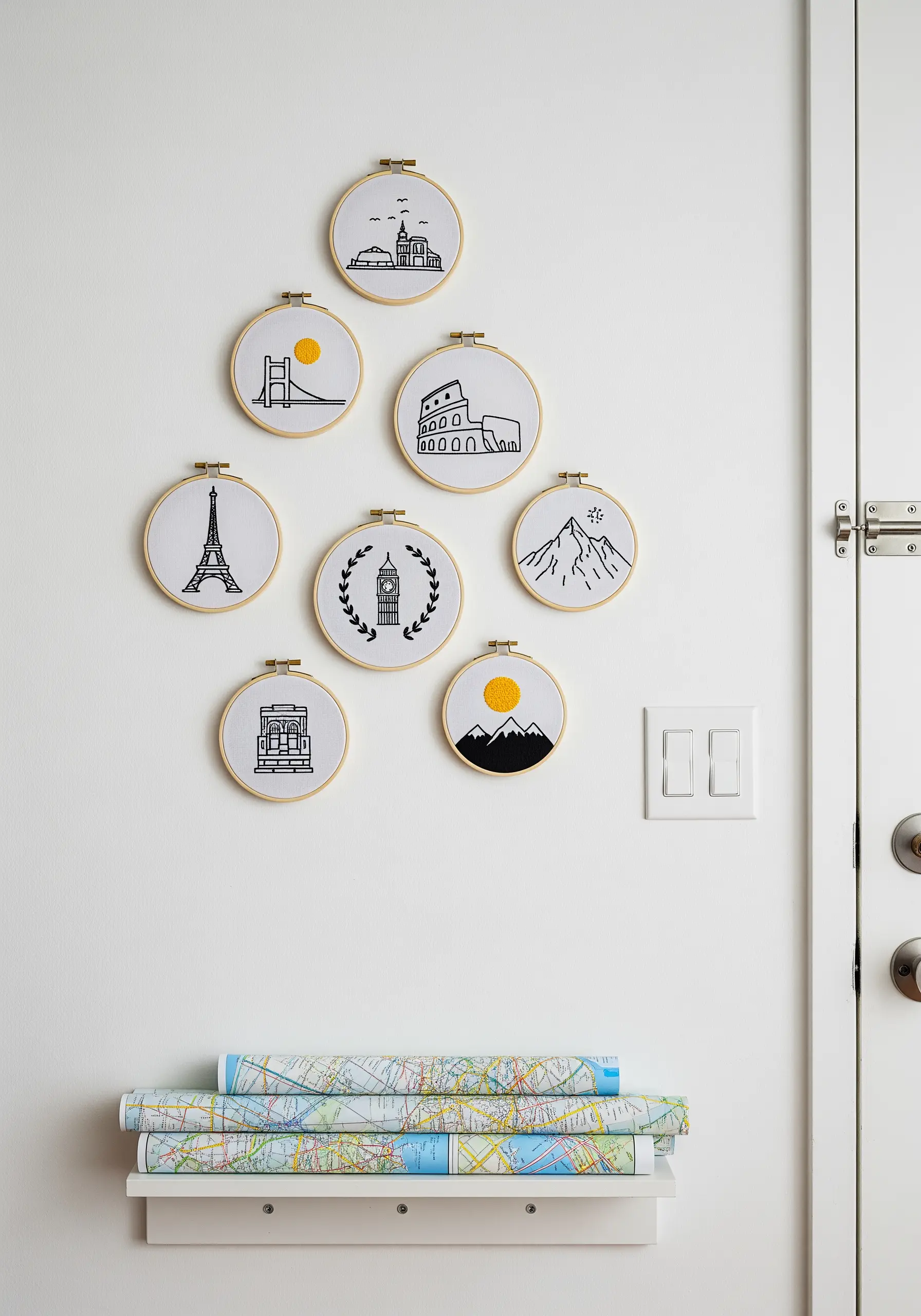 A collection of small embroidery hoops featuring minimalist icons of world travel landmarks.