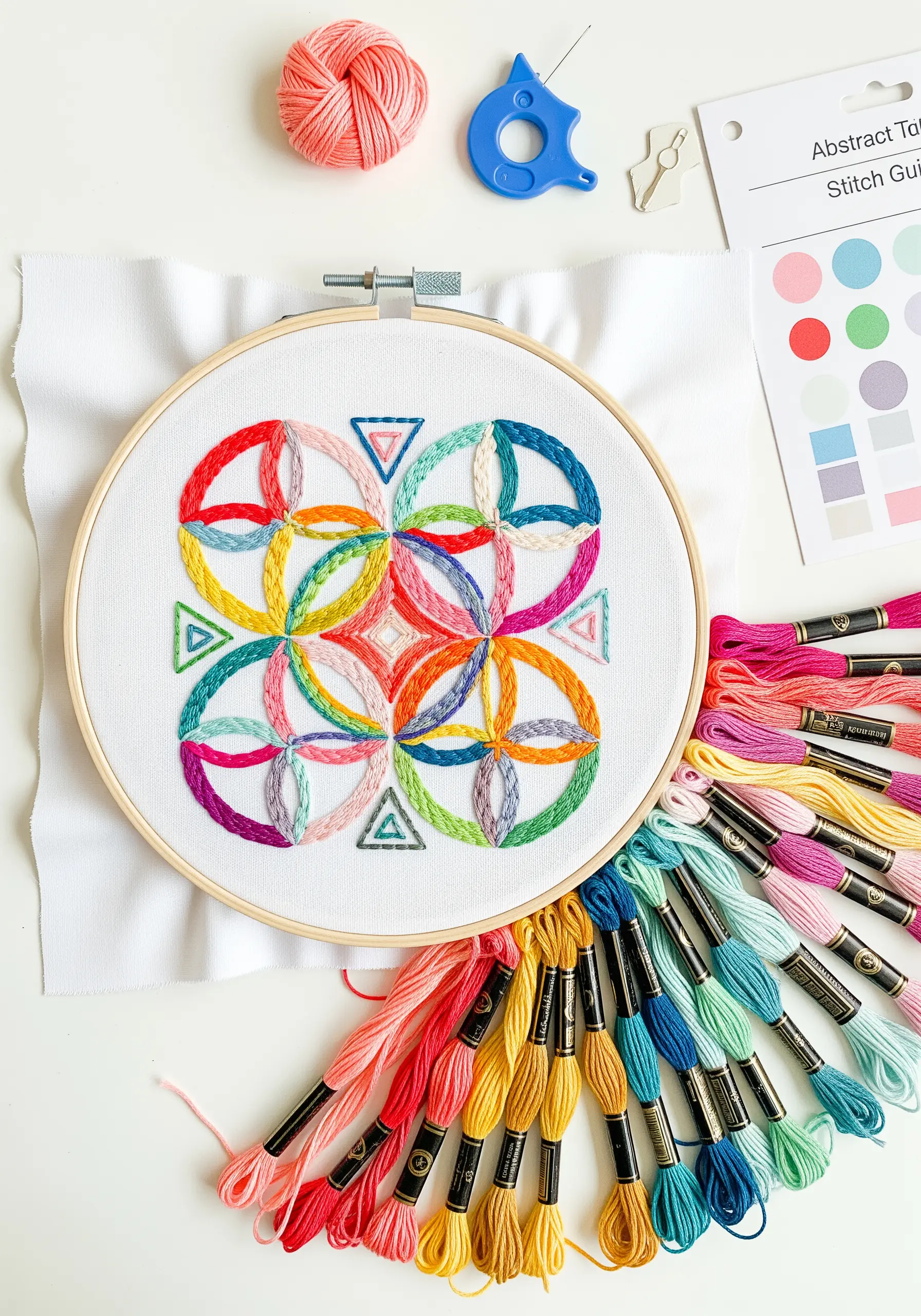 A colorful geometric embroidery pattern with interwoven circles and vibrant threads.
