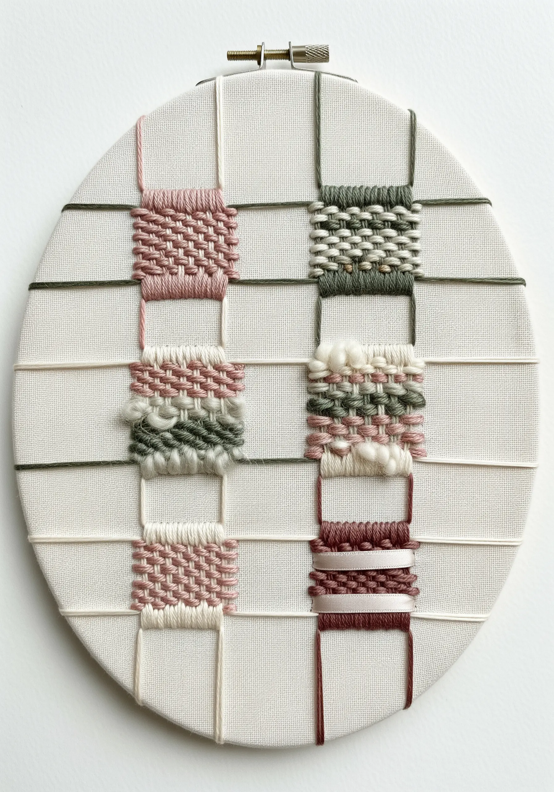 Small woven squares in pink, green, and white on a thread grid.