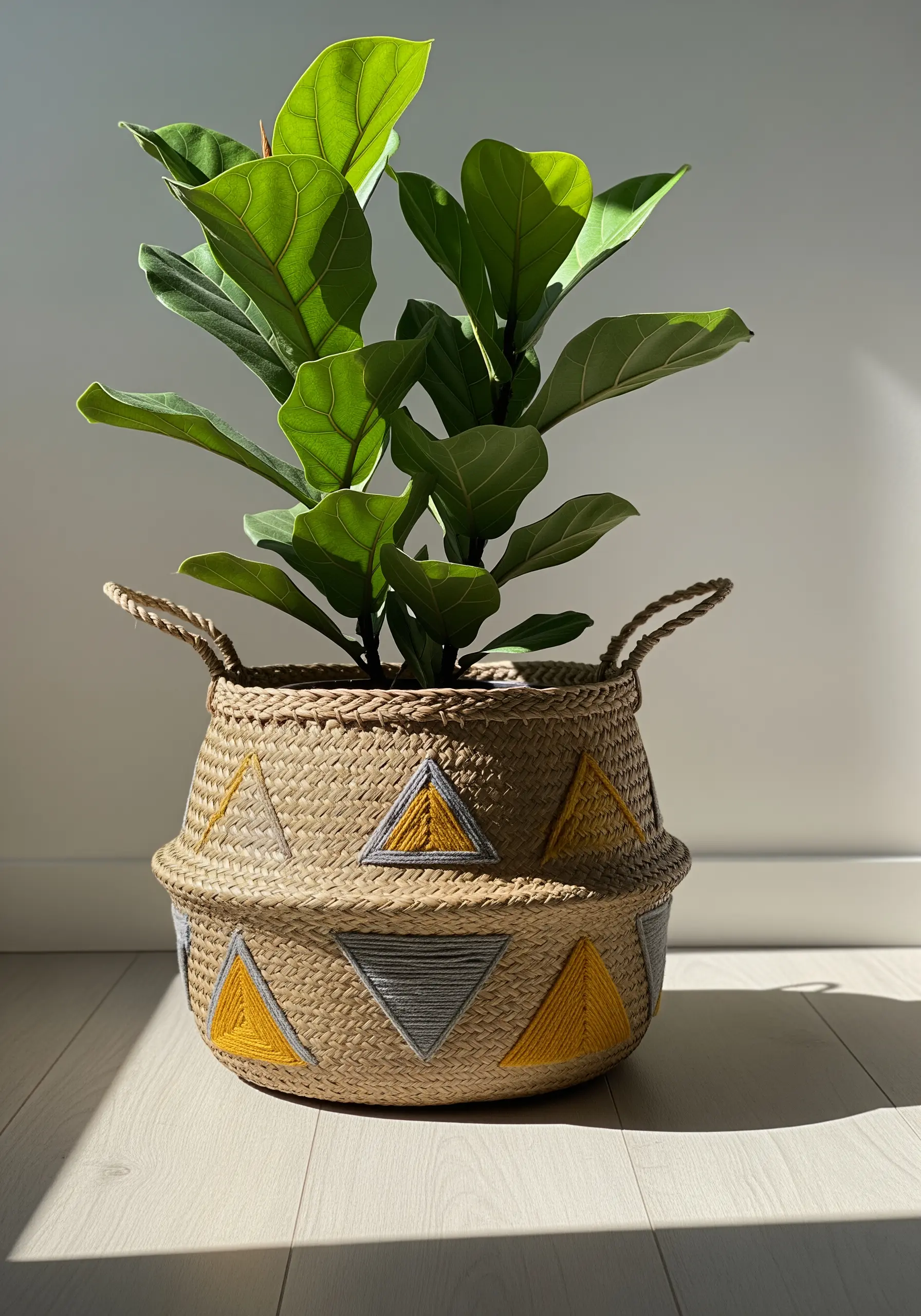 Woven belly basket with yellow and grey geometric embroidery